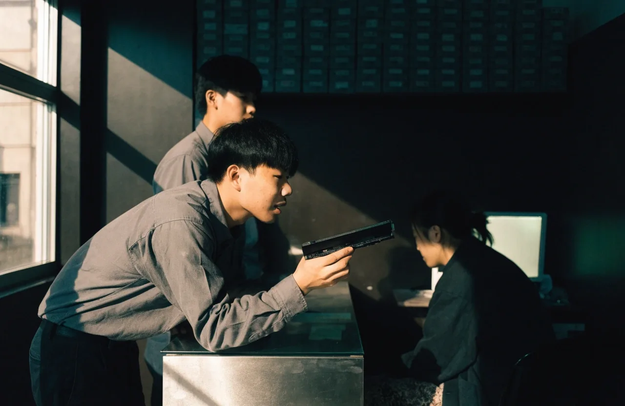 Three shop staff at the counter of a compact Busan hardware store