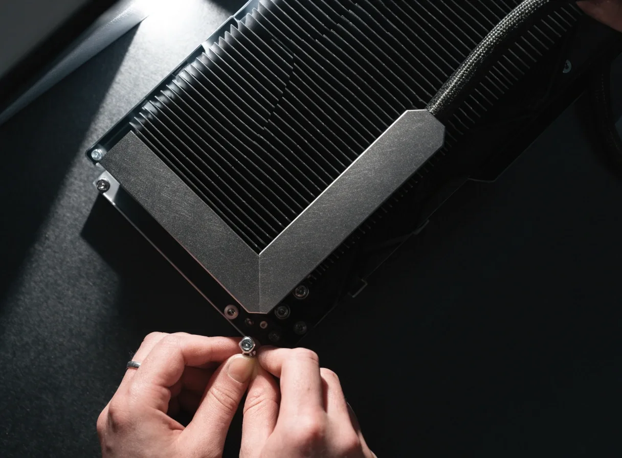 Hands fitting a graphics card into a desktop build on a workbench