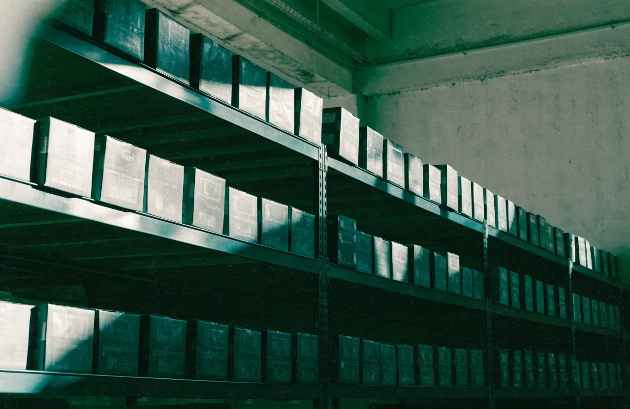 Graphics-card boxes stacked on metal shelving at the Busan counter under early daylight